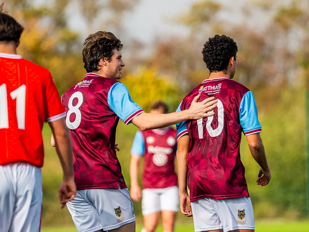 Two SSFC players celebrating during match.